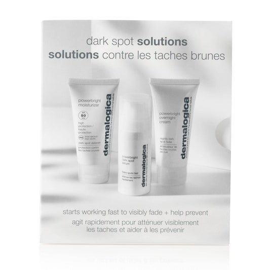 Drei Hautpflegeprodukte von Dermalogica aus der 'Dark Spot Solutions'-Serie, aufgestellt vor einer Werbetafel mit Produktbeschreibungen.