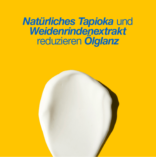 Weiße Cremesubstanz auf gelbem Hintergrund mit Text "Natürliches Tapioka und Weidenrindenextrakt reduzieren Ölglanz".