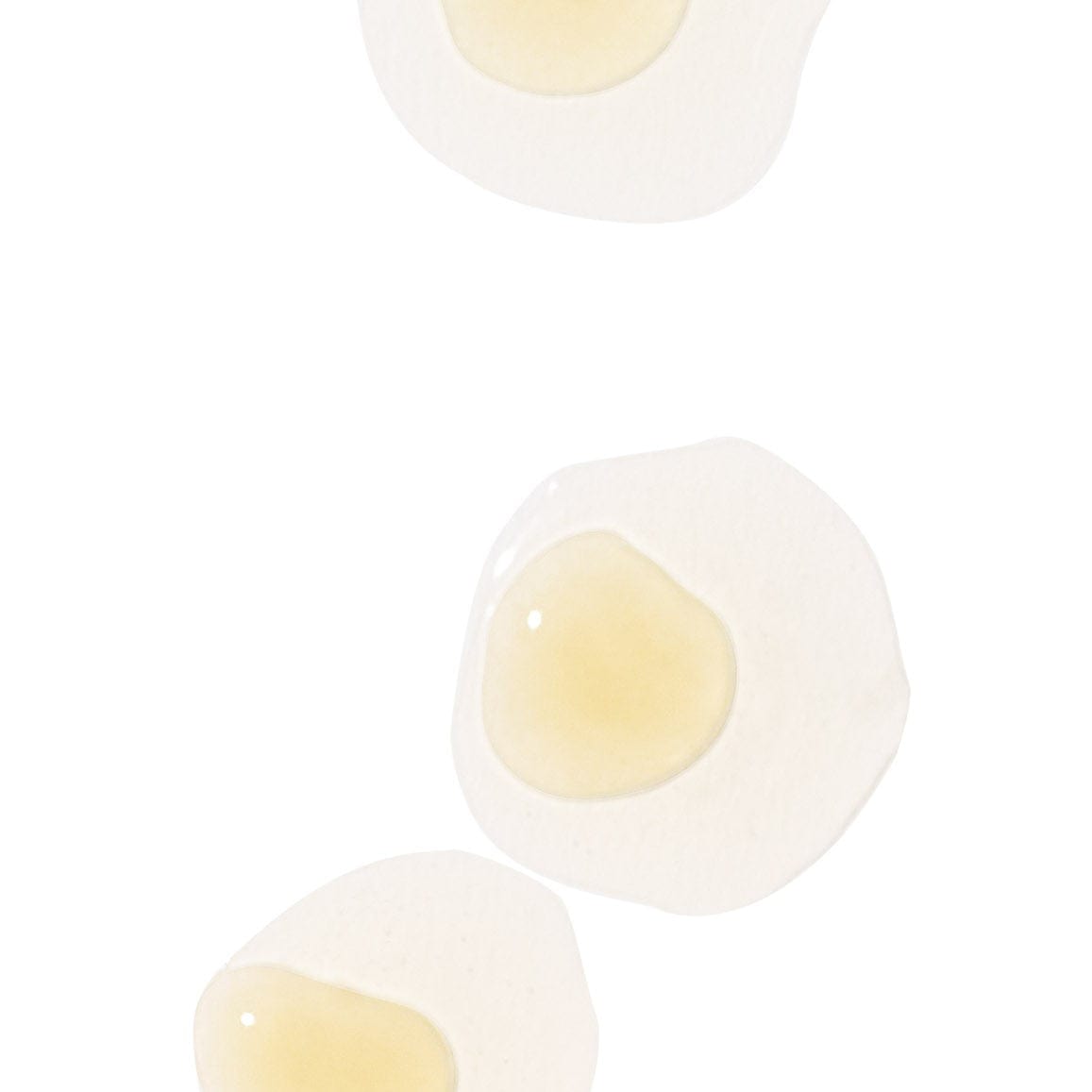 Drei runde weiße Flecken mit einer transparenten Gelmitte auf weißem Hintergrund.