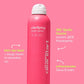 Eine pinkfarbene Flasche Clarifying Body Spray von gegen einen pinken Hintergrund.