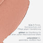Ein Muster des pfirsichfarbenen Creme-Make-ups mit der Aufschrift "SkinPerfect Primer SPF30" und einem deutschen Text, der es als 3-in-1-Make-up-Grundierung, Sonnenschutz und Anti-Age-Pflege für glatte, gesunde Haut beschreibt.