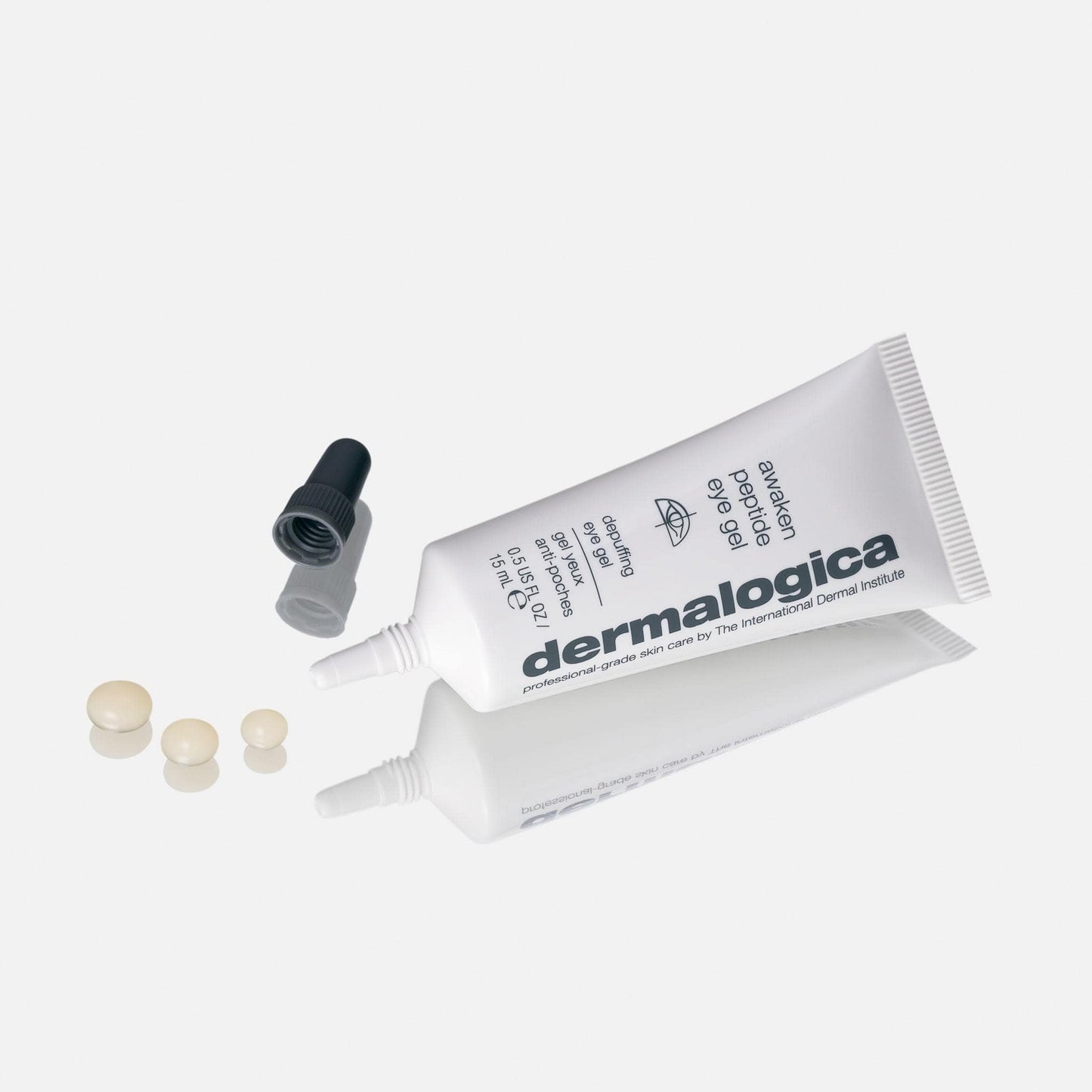 Dermalogica Hautpflegeprodukt neben seiner geöffneten Verpackung mit einigen kleinen Perlen des Inhalts daneben.