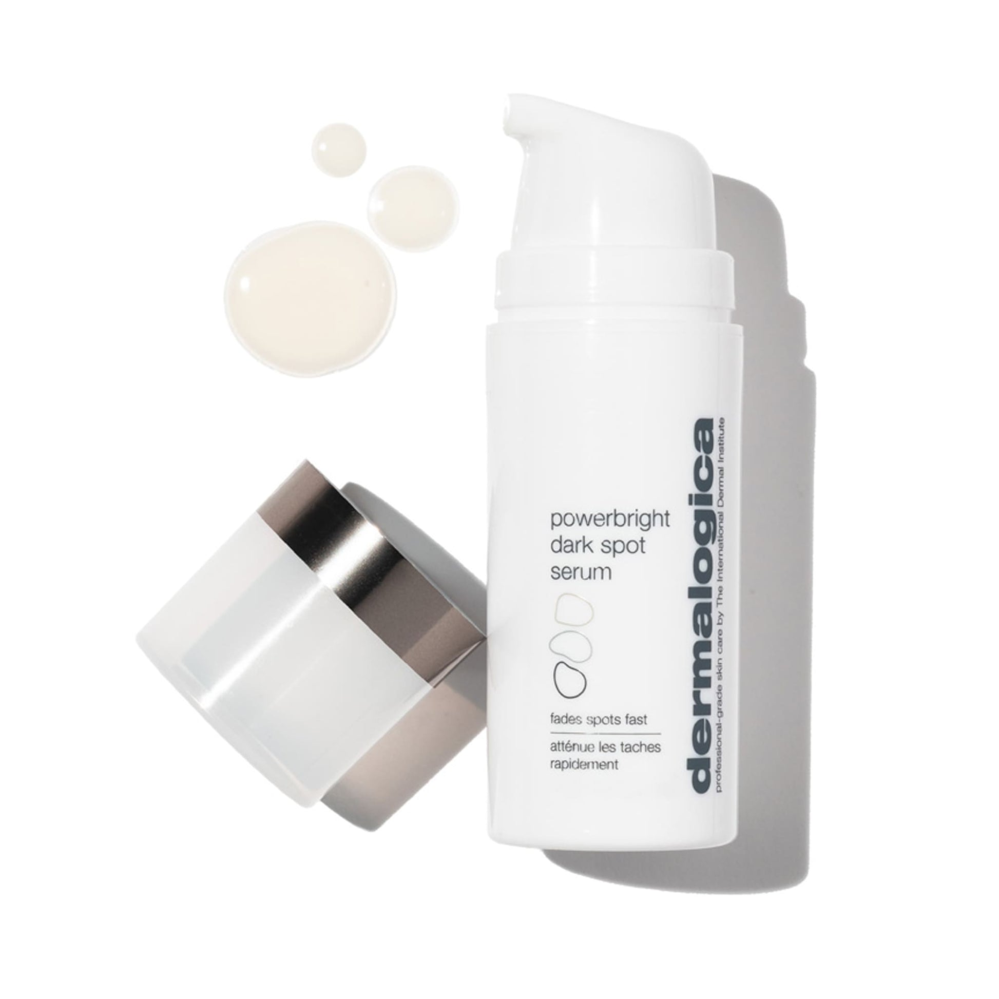 Weiße Flasche " Powerbright Dark Spot Serum" mit geöffnetem Deckel und einem Tropfen des Produkts daneben auf hellem Hintergrund.