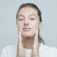 Eine Frau mit den Händen im Gesicht erhält PreCleanse 30 ml | Reinigungsöl-Behandlung.