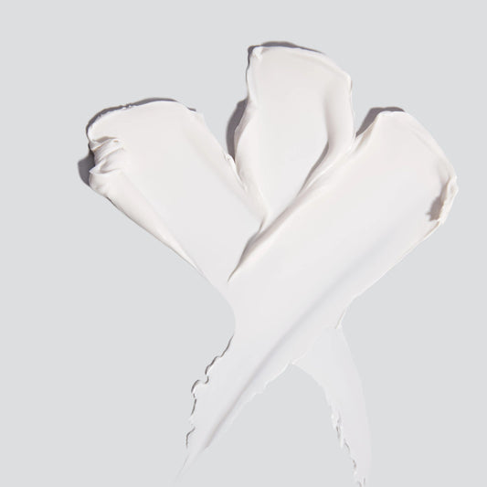 Ein weißer Invisible Physical Defense SPF30, 50 ml | Sonnenschutz-Creme auf grauem Hintergrund bietet physikalischen Lichtschutz und UV-Schutz und beugt Hautveränderungen vor.